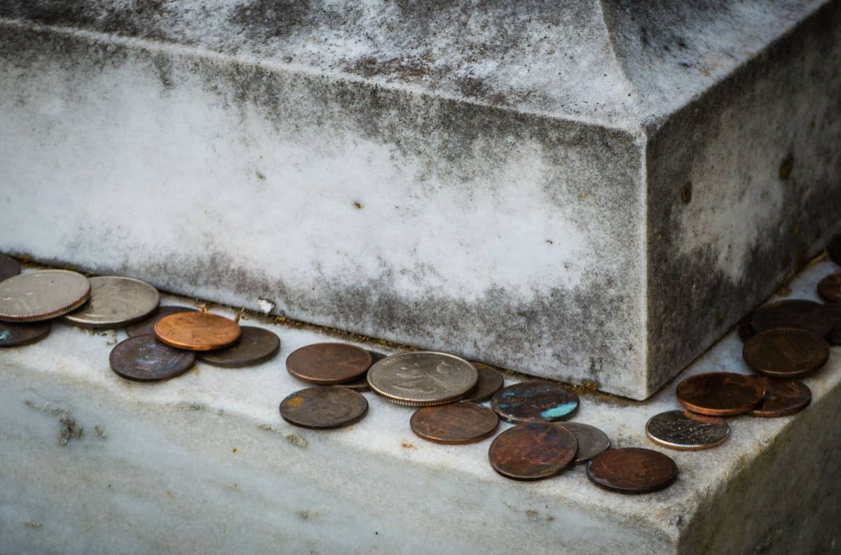 Coins on a gravesite (at the base of the tombstone)