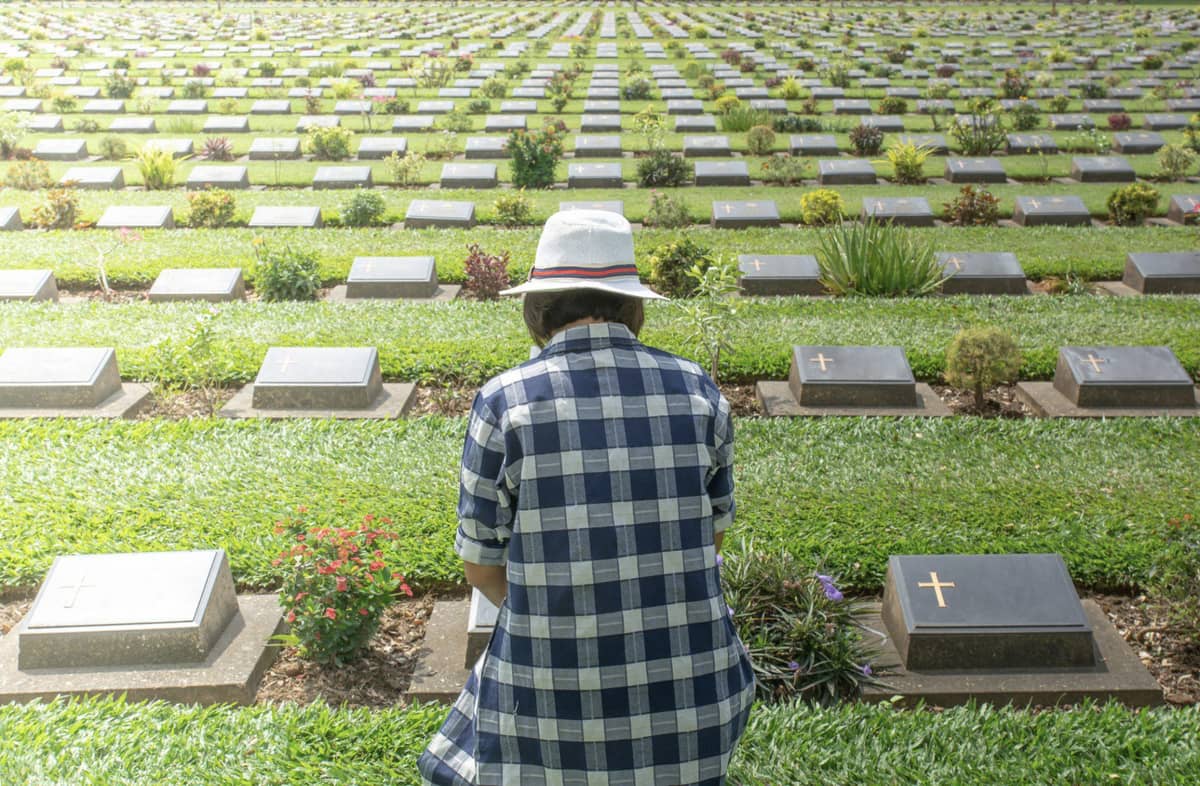 A person among rows of grave markers