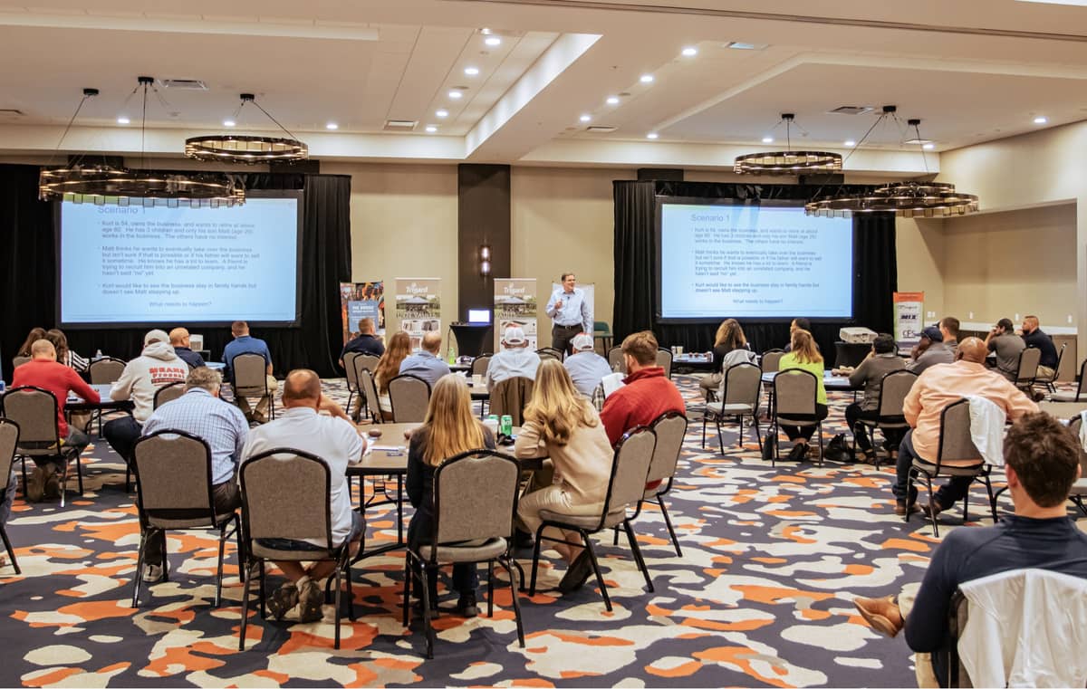 A workshop (people sitting at tables at a conference)