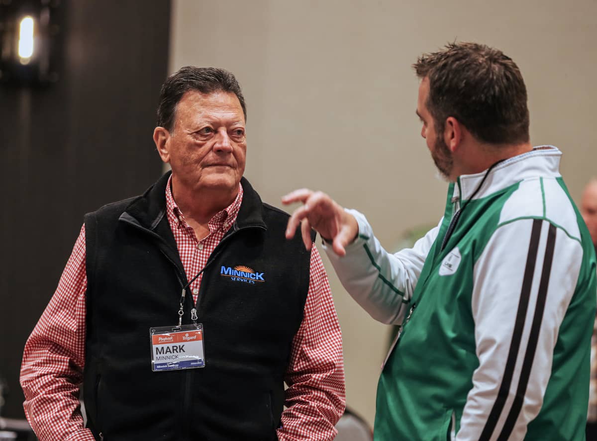 Two men talking at a conference