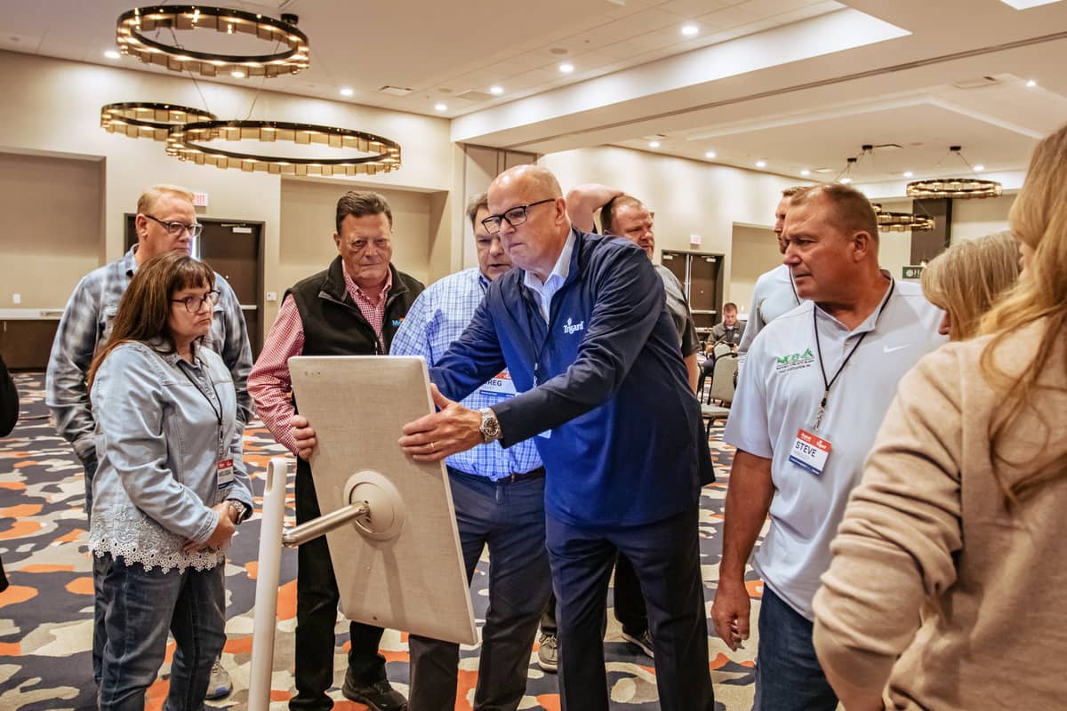A man showing info to other people at the conference